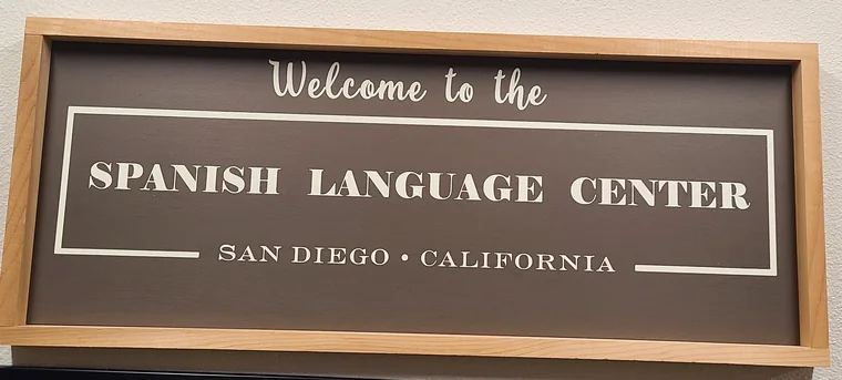The carved “Welcome to the Spanish Language Center — San Diego, California” sign in the school’s entrance